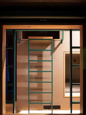 a room with a ladder in front of a door at ELE Cabin Shinjuku Kabukicho in Tokyo