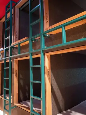 a stack of wooden shelves on a wall at ELE Cabin Shinjuku Kabukicho in Tokyo