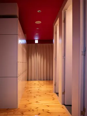 an empty hallway with a red ceiling and a wooden floor at ELE Cabin Shinjuku Kabukicho in Tokyo