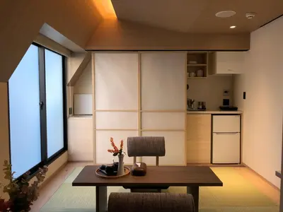 a dining room with a table and a kitchen at LiveGRACE Mabuji Park Hotel - Vacation STAY 51973v in Tokyo