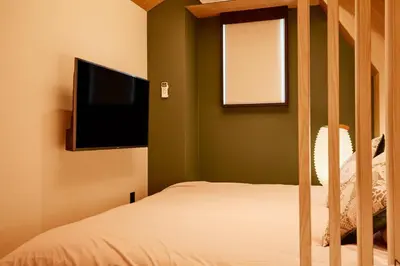a bedroom with a bed and a flat screen tv at LiveGRACE Mabuji Park Hotel - Vacation STAY 51973v in Tokyo
