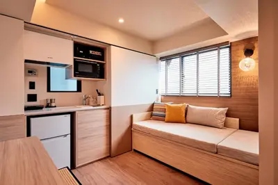 a small kitchen with a couch in a room at LiveGRACE Mabuji Park Hotel - Vacation STAY 51799v in Tokyo