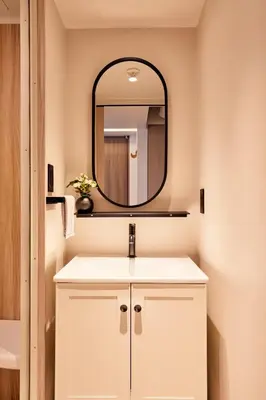 a bathroom with a white sink and a mirror at LiveGRACE Mabuji Park Hotel - Vacation STAY 51799v in Tokyo