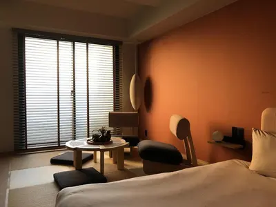 a bedroom with a bed and a table and a window at LiveGRACE Mabuji Park Hotel - Vacation STAY 51965v in Tokyo