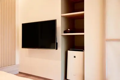 a living room with a tv and a radiator at LiveGRACE Mabuji Park Hotel - Vacation STAY 51965v in Tokyo
