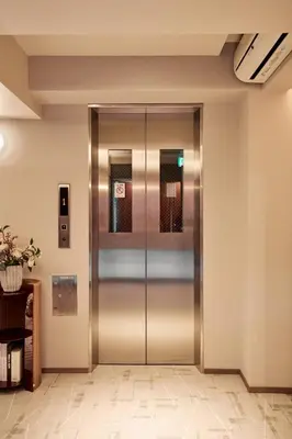 an elevator in a building with its doors open at LiveGRACE Mabuji Park Hotel - Vacation STAY 51965v in Tokyo