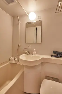 a bathroom with a sink and a toilet and a bath tub at LiveGRACE Mabuji Park Hotel - Vacation STAY 51980v in Tokyo