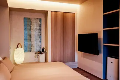 a bedroom with a bed and a flat screen tv at LiveGRACE Mabuji Park Hotel - Vacation STAY 51943v in Tokyo