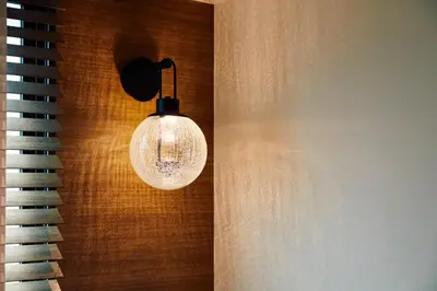 a light hanging from a wall next to a piano at LiveGRACE Mabuji Park Hotel - Vacation STAY 51943v in Tokyo