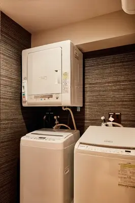 a microwave and a washer and dryer in a room at LiveGRACE Mabuji Park Hotel - Vacation STAY 51943v in Tokyo