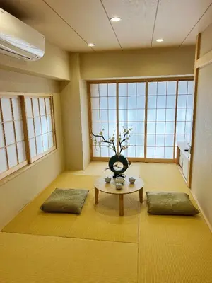 a room with a table with a vase on it at Akihabara K in Tokyo