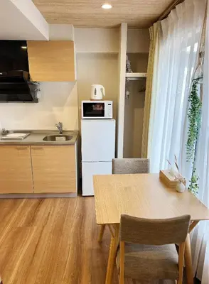a kitchen and dining room with a wooden table at Akihabara K in Tokyo