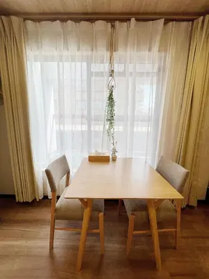 a wooden table and chairs in front of a window at Akihabara K in Tokyo