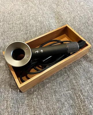 a black hair dryer in a wooden box at Akihabara K in Tokyo