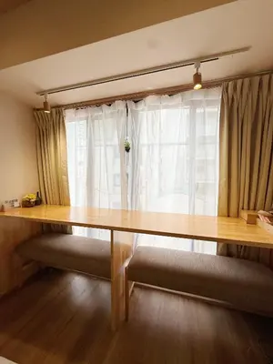 a wooden table in a room with a window at Akihabara K in Tokyo