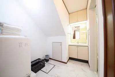 a small white bathroom with a sink and a mirror at la3 hotel annex \u65b0\u5bbf\u4e09\u968e\u5efa\u3066\u4e00\u8ed2\u5bb6 in Tokyo