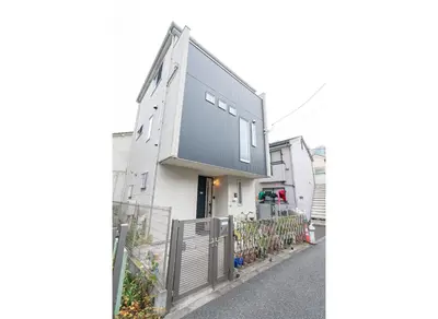a white house with a black roof on a street at 3 BR house 7 mins on foot from Otsuka on the Yamanote Line in Tokyo