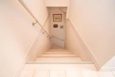 a staircase in a house with white walls at 3 BR house 7 mins on foot from Otsuka on the Yamanote Line in Tokyo