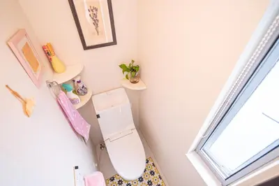 a bathroom with a toilet and shelves on the wall at 3 BR house 7 mins on foot from Otsuka on the Yamanote Line in Tokyo