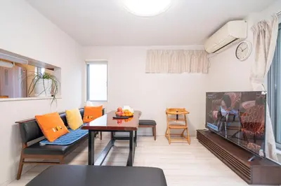 a living room with a couch a table and a tv at 3 BR house 7 mins on foot from Otsuka on the Yamanote Line in Tokyo