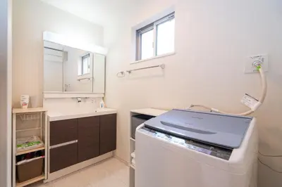 a bathroom with a sink and a washing machine at 3 BR house 7 mins on foot from Otsuka on the Yamanote Line in Tokyo