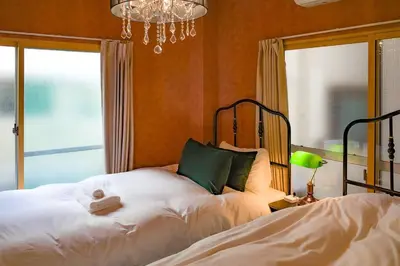 a bedroom with a bed and a chandelier at 1F Facing Skdytree 6min stn Direct NRT&HND&Disney in Tokyo