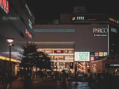 a busy city street at night with people walking around at 1F Facing Skdytree 6min stn Direct NRT&HND&Disney in Tokyo