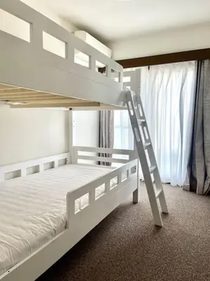a white bunk bed in a room with a ladder at \u6c60\u888b\u4e09\u99c5\u306e\u5bb6 \u5927\u5c71\u99c5\u304b\u3089\u5f92\u6b694\u5206 in Tokyo