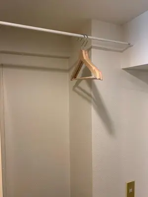 a closet with a wooden hanger in a room at Studio in the center of Shibuya \u6e0b\u8c37\u9053\u7384\u5742 in Tokyo