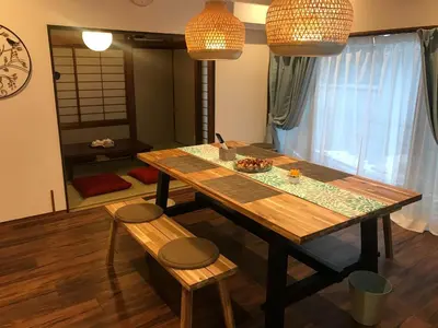 a dining room table with two chairs and two lights at HIDAKA STAY VILLA \u67f4\u53c8 in Tokyo