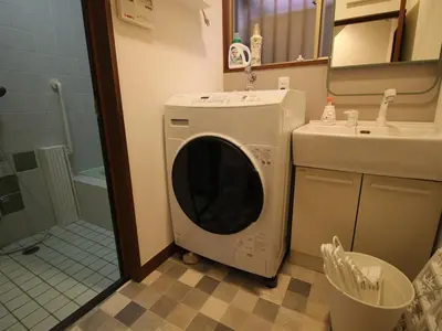 a washing machine in a bathroom next to a sink at HIDAKA STAY VILLA \u67f4\u53c8 in Tokyo
