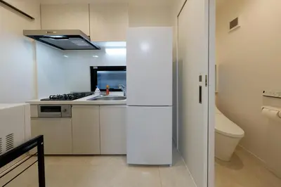 a kitchen with a white refrigerator and a sink at Setagaya House by Tranova in Tokyo