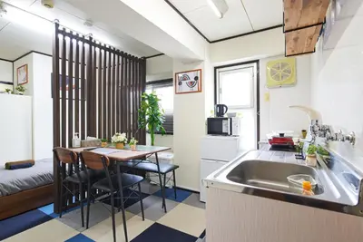 a kitchen with a sink and a table with chairs at Ryogoku 601 Private Cozy Stay 4min Walk Station Asakusa Nearby in Tokyo