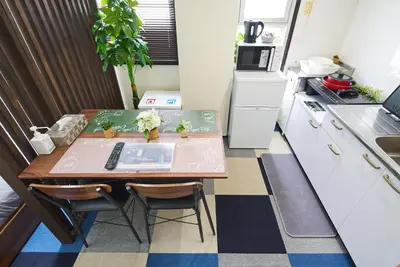 a small kitchen with a wooden table and a table at Ryogoku 601 Private Cozy Stay 4min Walk Station Asakusa Nearby in Tokyo