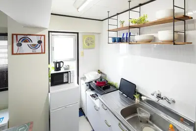 a kitchen with a sink and a computer on a counter at Ryogoku 601 Private Cozy Stay 4min Walk Station Asakusa Nearby in Tokyo