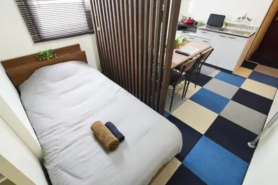 a bed with a towel on it in a room at Ryogoku 601 Private Cozy Stay 4min Walk Station Asakusa Nearby in Tokyo