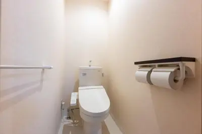 a bathroom with a toilet and a toilet paper dispenser at LUANAHOTEL IN SINNAKANO in Tokyo