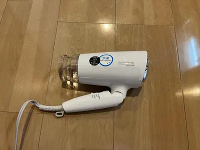 a electric hair dryer sitting on a wooden floor at LUANAHOTEL IN SINNAKANO in Tokyo