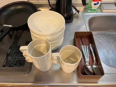 three empty cups sitting on a kitchen sink at LUANAHOTEL IN SINNAKANO in Tokyo