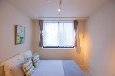 a bedroom with a bed and a window at Your best choice for travel in Yoyogi EoY6 in Tokyo