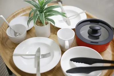 a table with white plates and a plant on it at Real Kinshi 201 in Tokyo