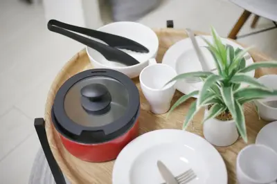 a table with plates and utensils on a wooden tray at Real Kinshi 201 in Tokyo