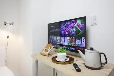 a computer monitor on a desk with a cup of coffee at Real Kinshi 201 in Tokyo