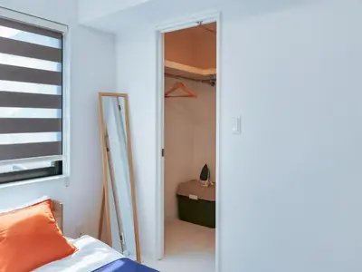 a bedroom with a door leading to a closet at 2023 Open Shinjuku Okubo 5mins to 2stns 200M WIFI in Tokyo