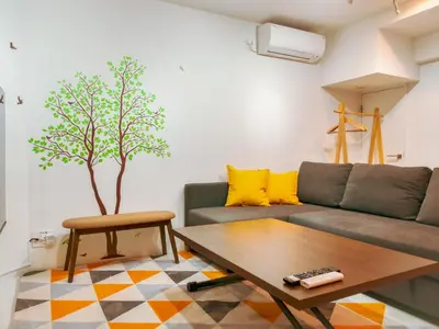 a living room with a couch and a table at 2023 Open Shinjuku Okubo 5mins to 2stns 200M WIFI in Tokyo