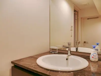 a bathroom with a white sink and a bath tub at 2023 Open Shinjuku Okubo 5mins to 2stns 200M WIFI in Tokyo