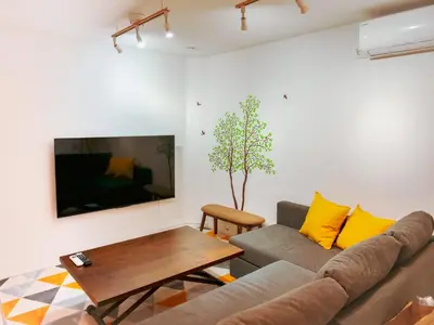 a living room with a couch and a table at 2023 Open Shinjuku Okubo 5mins to 2stns 200M WIFI in Tokyo