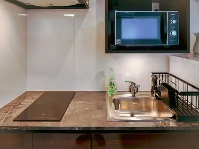 a kitchen counter with a sink and a microwave at 2023 Open Shinjuku Okubo 5mins to 2stns 200M WIFI in Tokyo