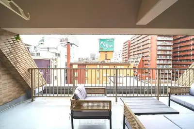 a balcony with chairs and tables on a balcony at \u30ac\u30a4\u30a2\u6b4c\u821e\u4f0e\u753a\u58f1\u756a\u9928602 in Tokyo