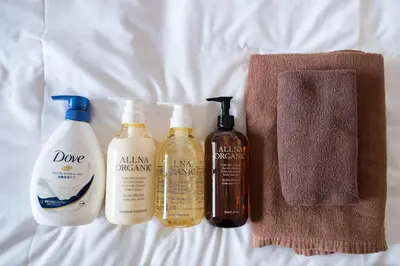 a group of four bottles of hair products on a bed at \u30ac\u30a4\u30a2\u6b4c\u821e\u4f0e\u753a\u58f1\u756a\u9928602 in Tokyo